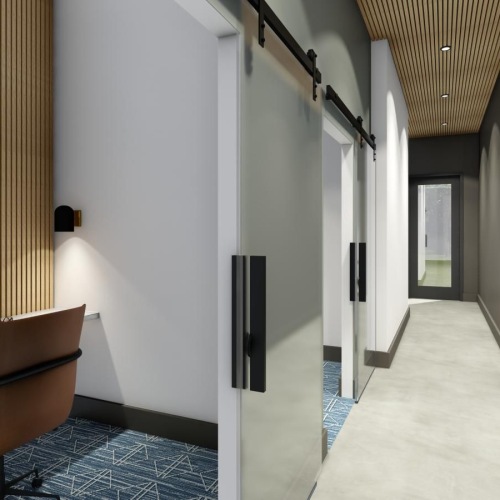 a hallway with a desk and a computer