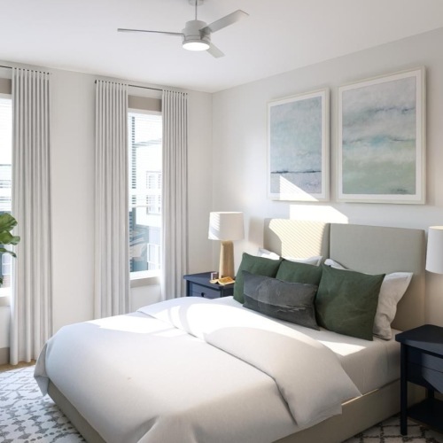 a bedroom with a bed and a fan