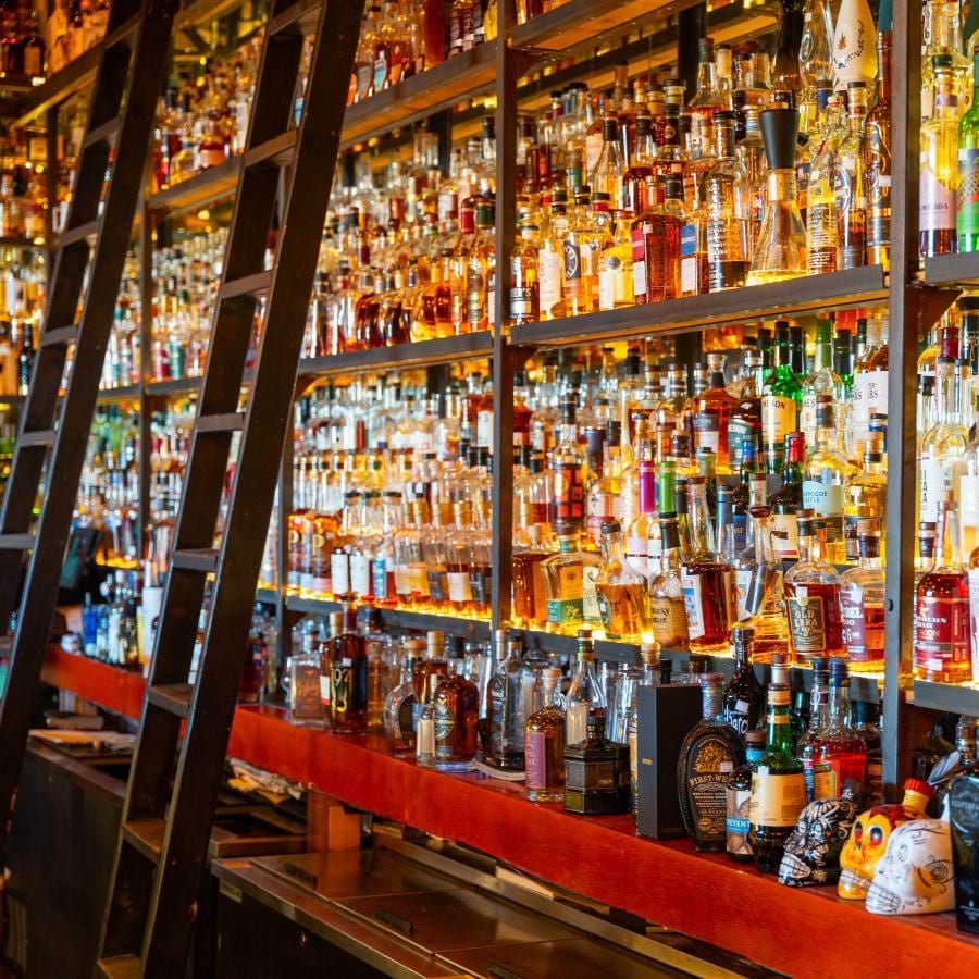 a bar with many bottles of alcohol