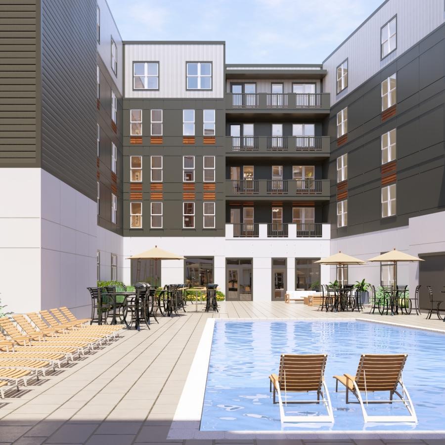 a pool and chairs outside a building